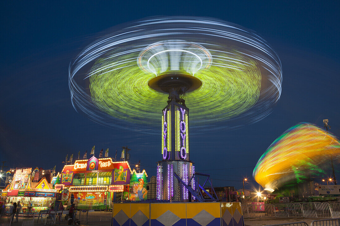 The colorfully illuminated Yo Yo spins on the midway at the Tennessee State Fair on September 5, 2014 at the Tennessee Fairgrounds in Nashville, Tennessee.