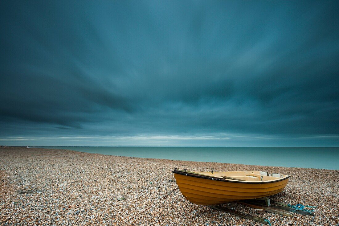 Modern rowing boat on the beach in Dungeness, Kent, England, United Kingdom.