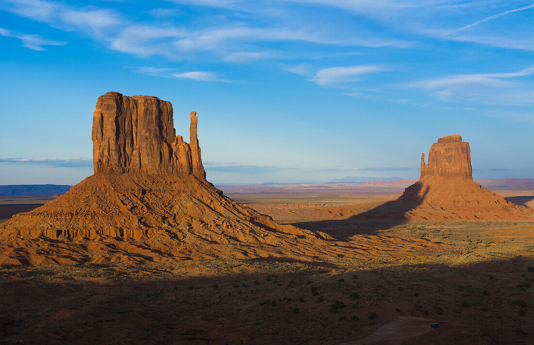 Monument Valley Utah desert mittens in panoramic of Western landscape at sunset Natioanal Park shadow of one mitten on another.
