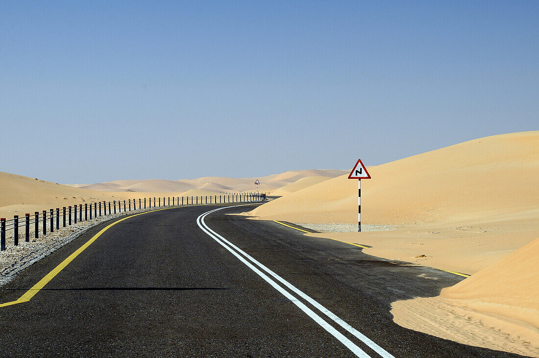 Road through the sand dunes of the empty quarter desert. United Arab Emirates, UAE, Abu Dhabi, Liwa Oasis, Moreeb Hill, Tal Mireb.