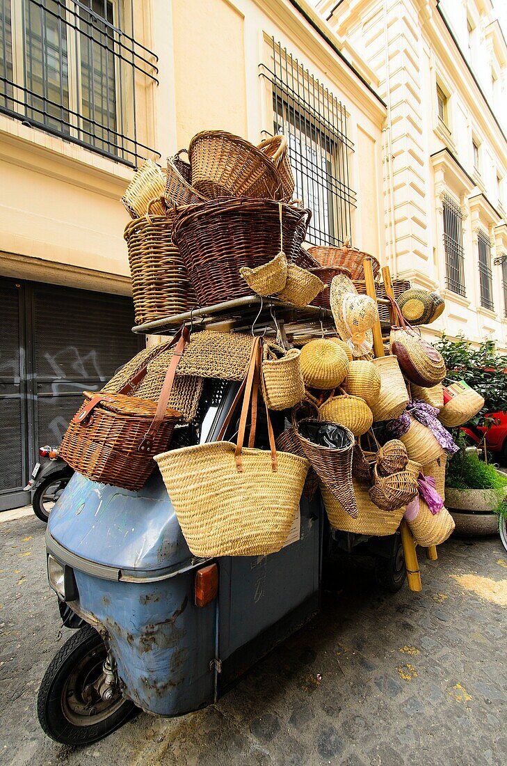 Baskets and straw bags over an Ape Car - Rome, Italy.