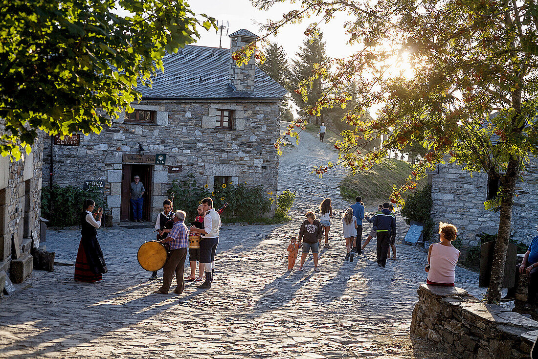 Sunset in the village of Cebreiro while a group plays the bagpipes.