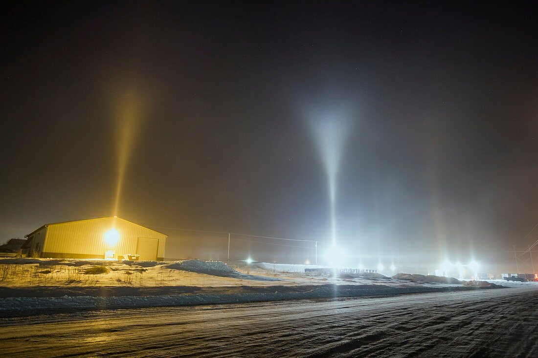Y-shape light pillars form in Blair Nebraska in freezing temps and from conditions related to steam production from a corn milliing plant. At times the V shape on top was nested with another V above it, which is rare.