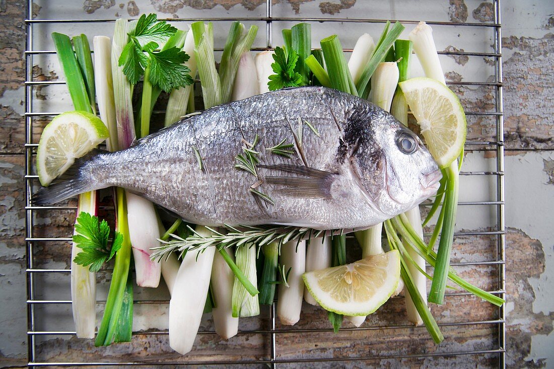 Presentation and preparation of a second dish of sea bream and onions.