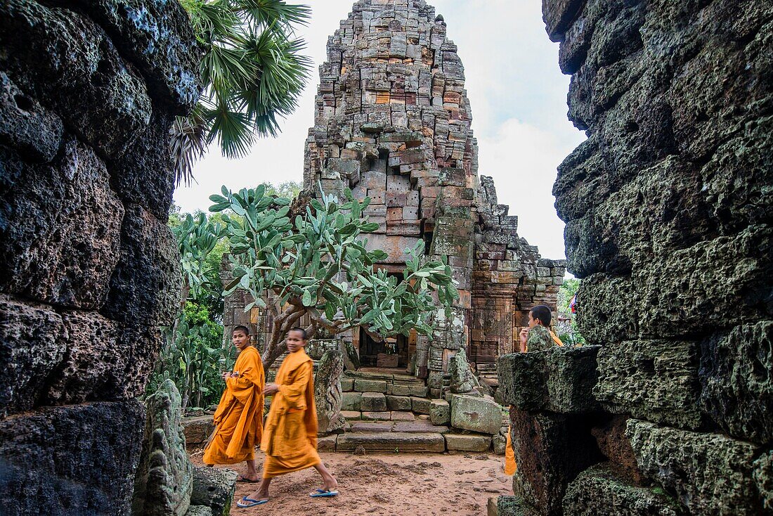 Monks visiting the Wat Banan. It is a small temple with five towers, which sits on top of a hill close to the Sanker river. Kantueu Pir commune, Banan district, Battambang province, Cambodia, Southeast Asia.