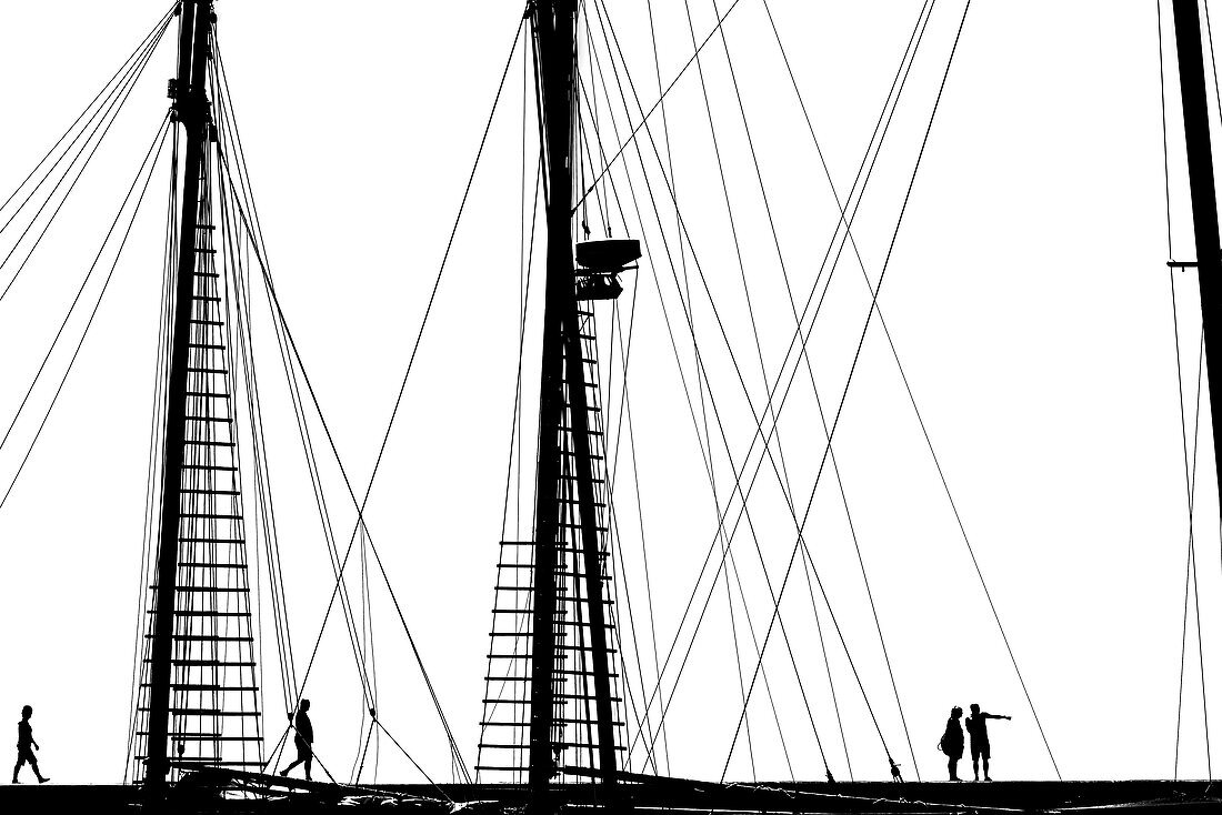 People on the mole in the harbour in front of the rigging of an old sailing ship, Benalmadena, Andalusia, Spain