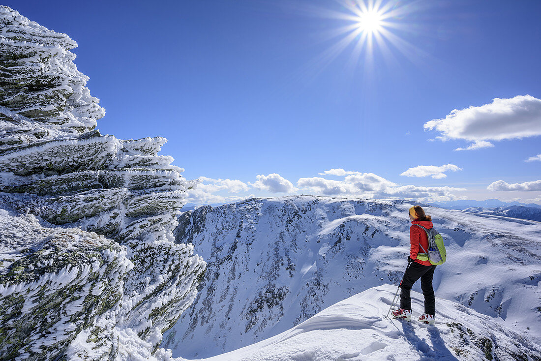 Woman ascending to Falkert, rime ice at rocks, Falkert, Nock Mountains, Biosphaerenpark Nockberge, Carinthia, Austria