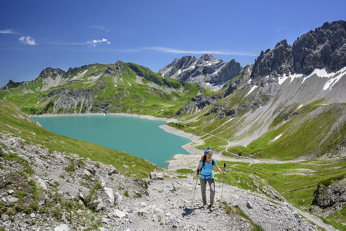 Woman hiking with lake Luenersee in background, lake Luenersee, Raetikon trail, Raetikon, Vorarlberg, Austria