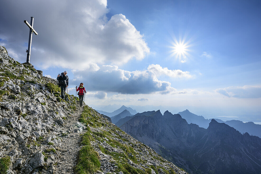 Woman and man descending from Ammergauer Hochplatte, Ammergauer Hochplatte, Ammergau Alps, East Allgaeu, Allgaeu, Swabia, Bavaria, Germany