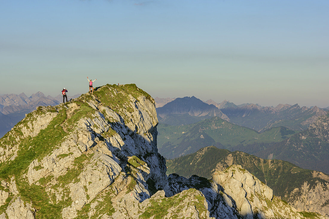 Two persons hiking and posing, Ammergauer Hochplatte, Ammergau Alps, East Allgaeu, Allgaeu, Swabia, Bavaria, Germany