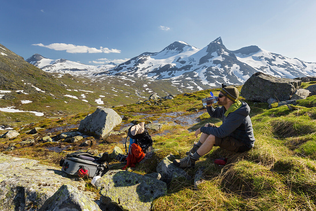 Wanderer bei der Rast, trinkend, Rauddalstindane, Gravdalen, Jotunheimen Nationalpark, Sogn og Fjordane, Norwegen