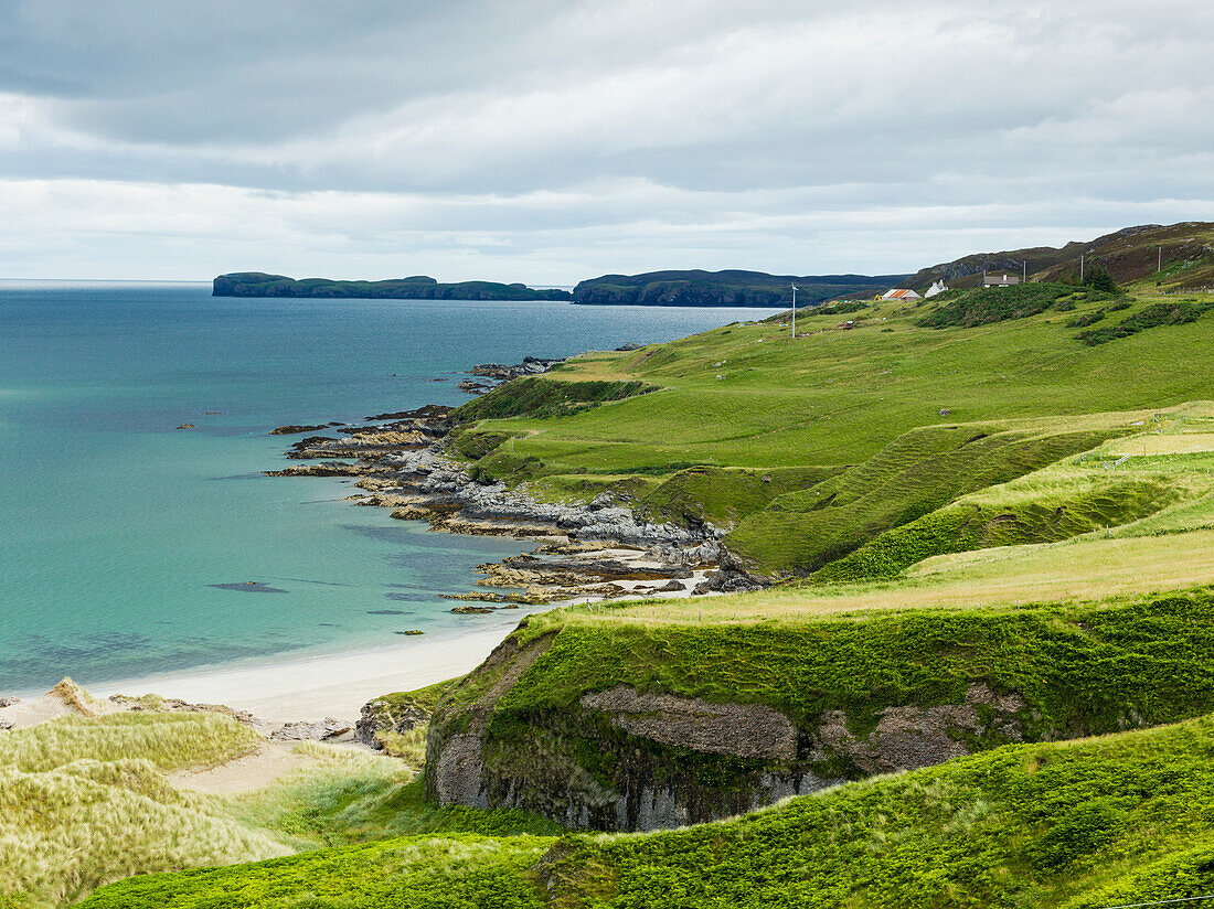 'Grass slopes along the rugged coastline; Scotland'