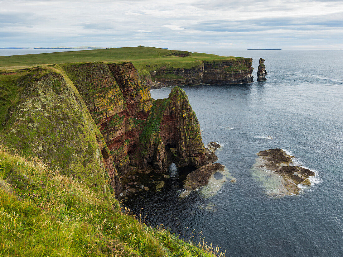 'Rugged cliffs and sea stacks along the coastline, Duncansby Head; Scotland'