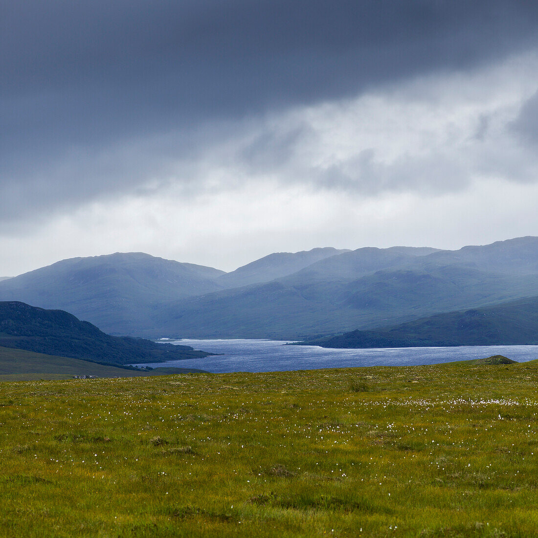 'Storm clouds and fog over the mountainous landscape and water in the Highlands; Scotland'