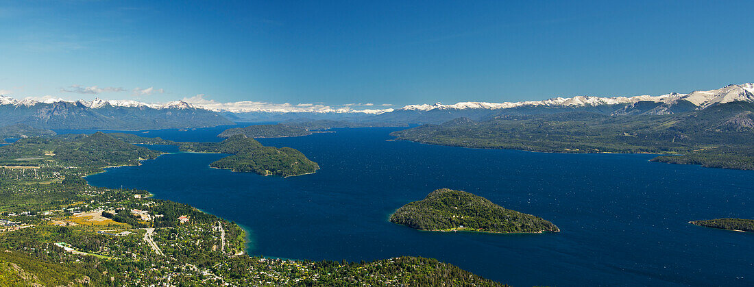 'Panoramic view of a large lake in Patagonia, with snow-capped mountains and blue sky; Argentina'