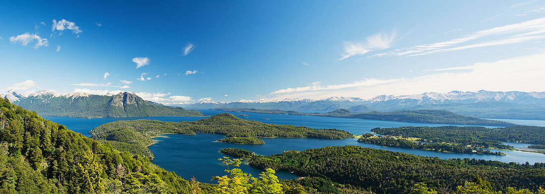 'Panoramic view of a large lake in Patagonia, with snow-capped mountains and blue sky; Argentina'