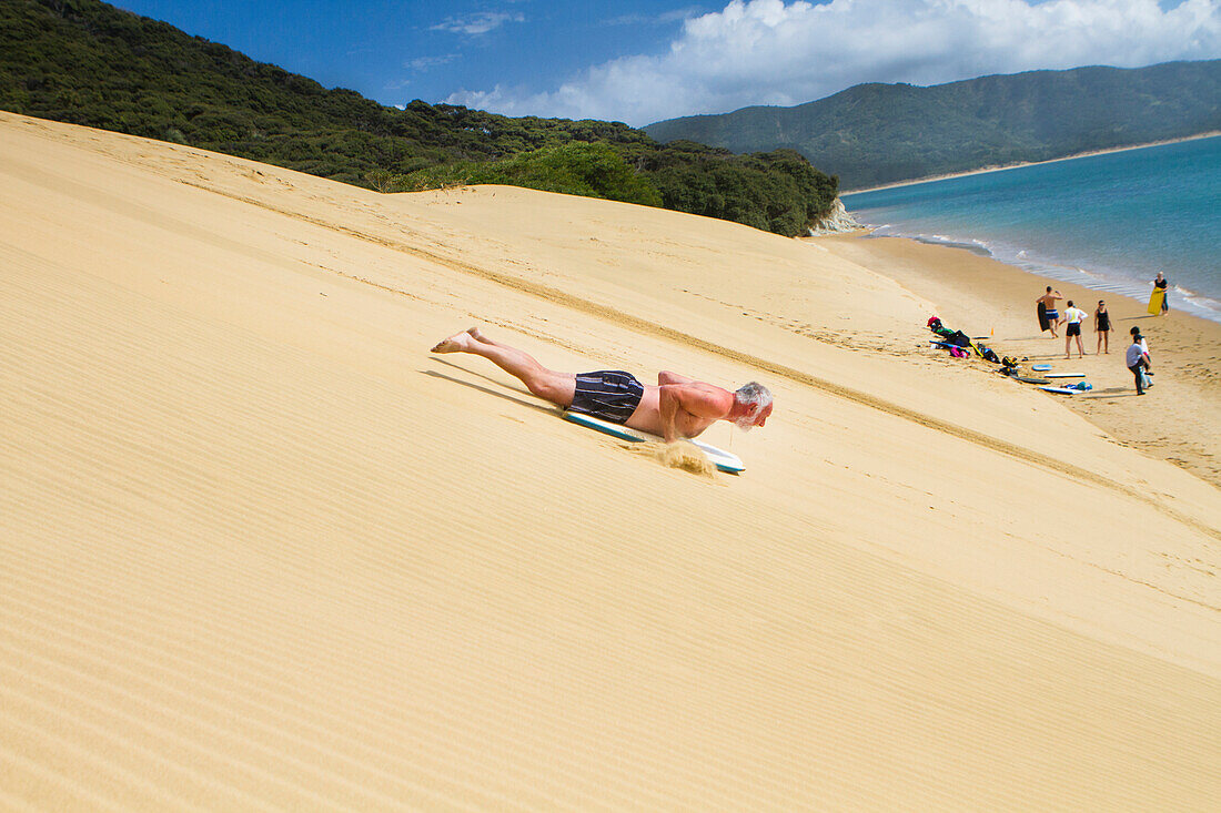 'Sand Boarding the Hokianga Sand Dunes on the Tasman Sea; Hokianga, New Zealand'