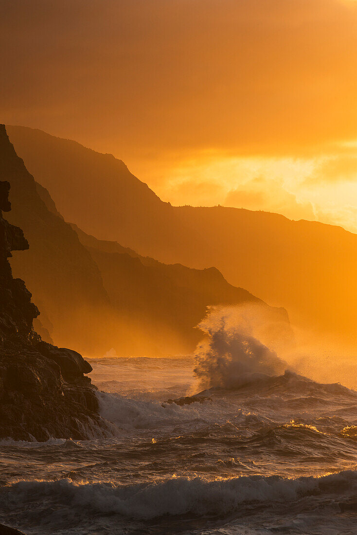'Surf breaks on the Na Pali coast at sunset; Kauai, Hawaii, United States of America'