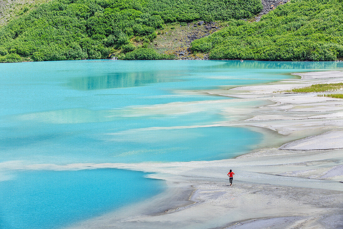 'Woman exploring the delta on Lake Louise in Banff National Park; Banff, Alberta, Canada'