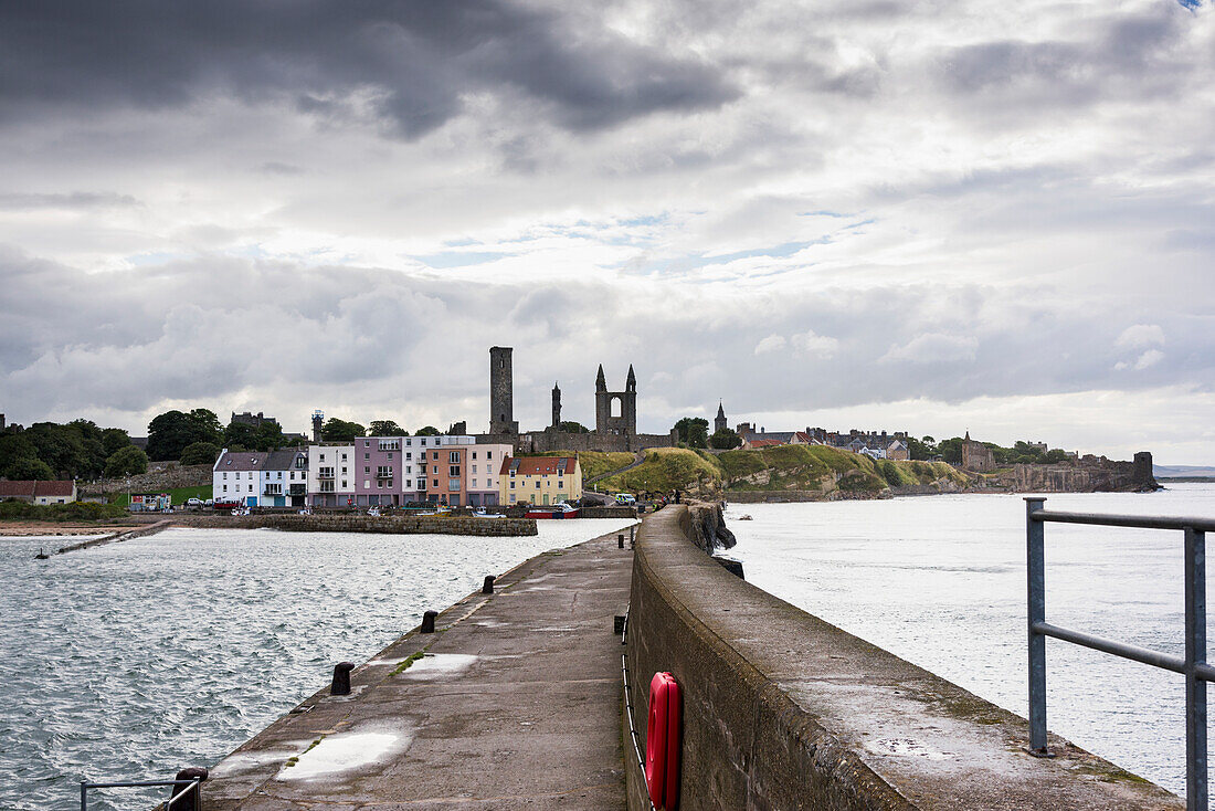 'A pier and colourful buildings along the harbour; St. Andrews, Fife, Scotland'