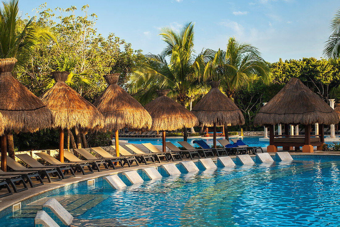 'Swimming pool and lounge chairs at a resort on the Caribbean; Playa del Carmen, Quintana Roo, Mexico'