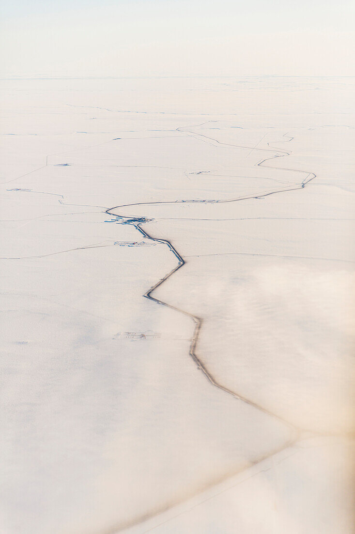 Aerial view of roads and other oil infrastructure on the Arctic tundra, Arctic Alaska, USA, Winter