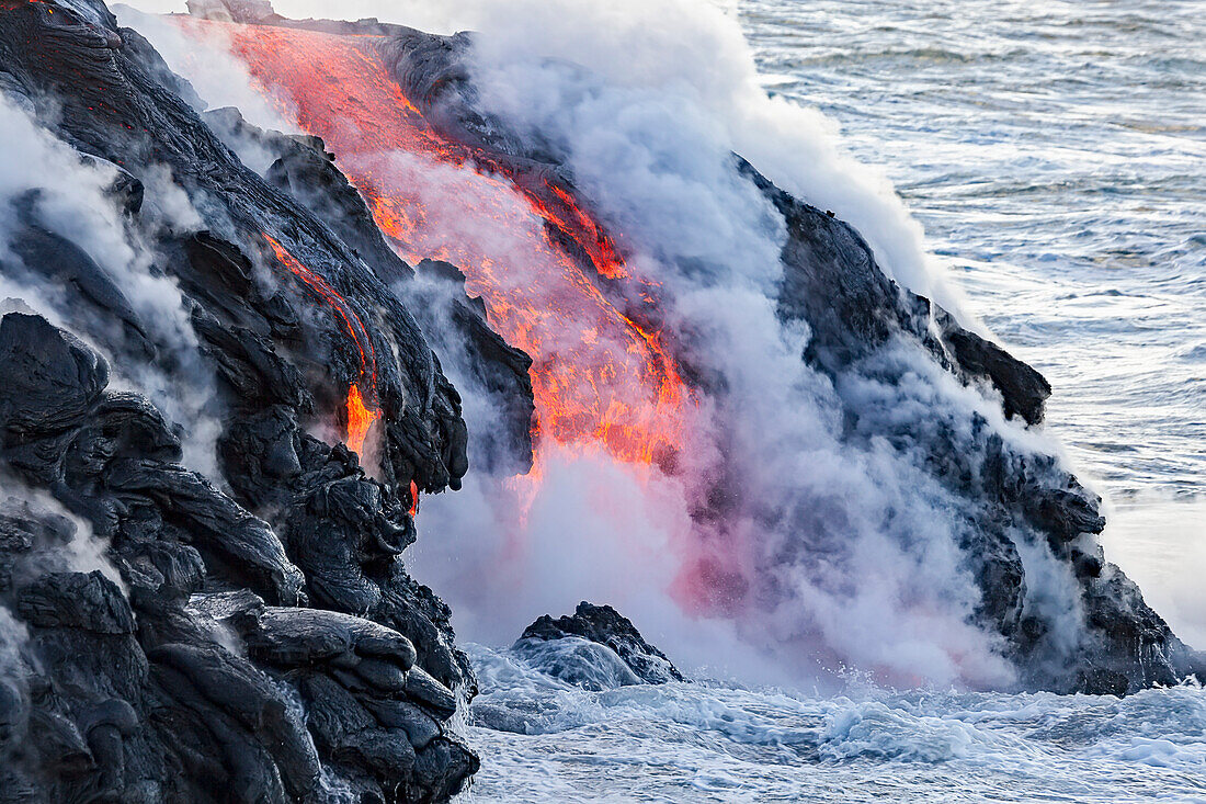 'The Pahoehoe lava flowing from Kilauea has reached the Pacific ocean near Kalapana; Island of Hawaii, Hawaii, United States of America'