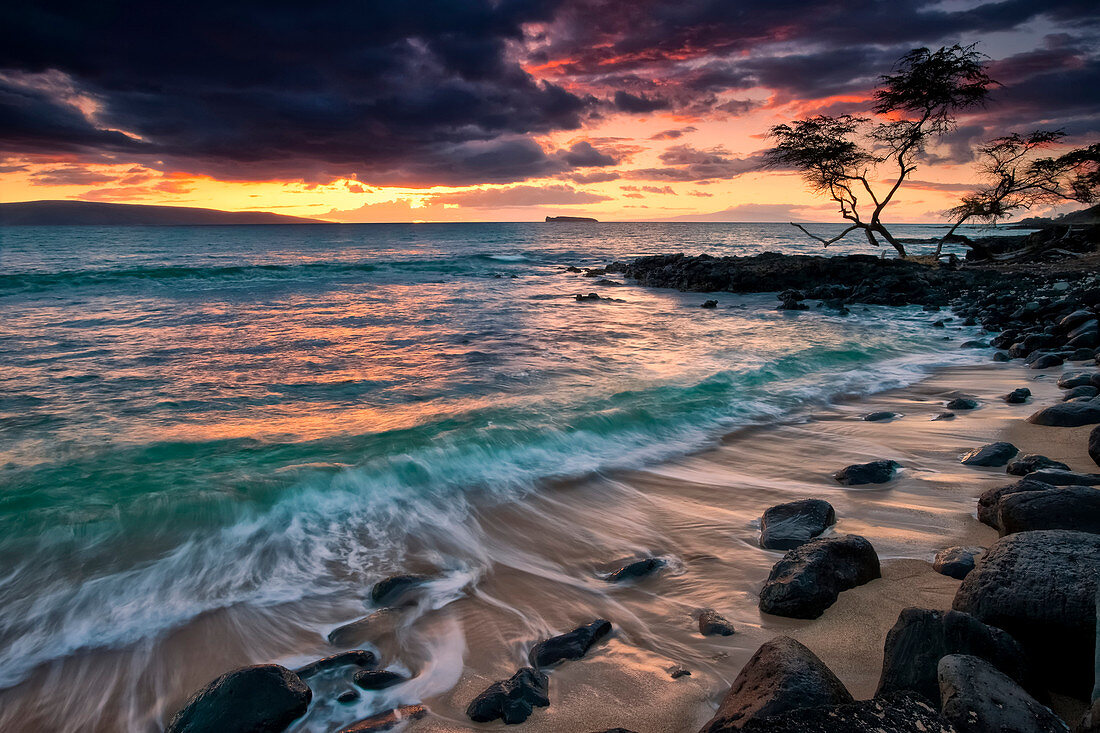 'A dramatic sky at sunset over a turquoise ocean along the coast of a hawaiian island; Hawaii, United States of America'
