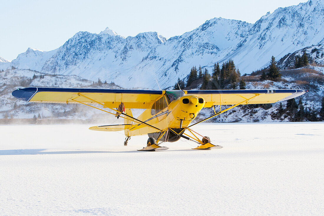 Piper PA-18 Super Cub on skis with the Kenai Mountains in the background, Southcentral Alaska.