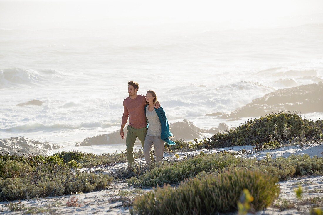 Happy couple walking on the beach