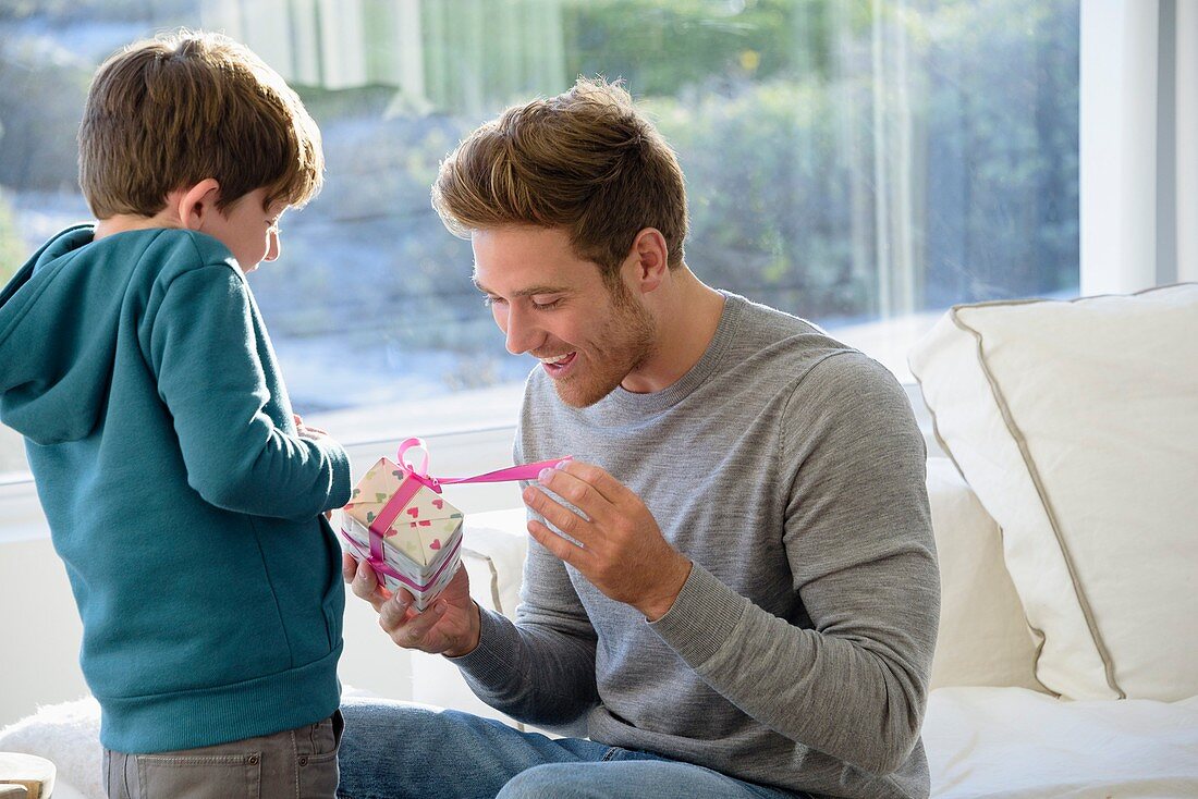 Happy father and son with birthday gift