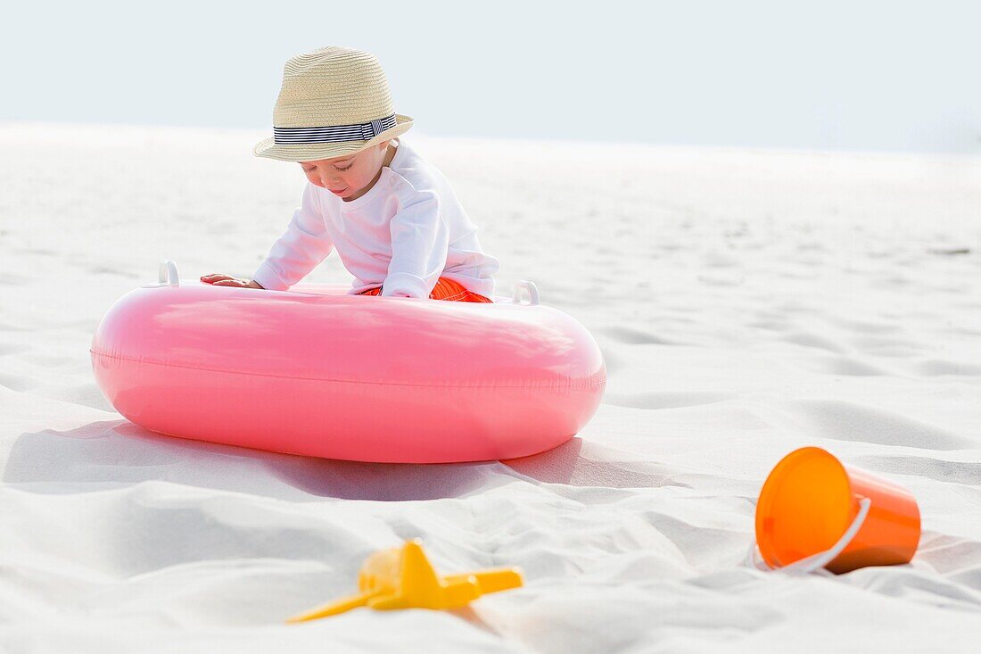 Baby boy playing on the beach