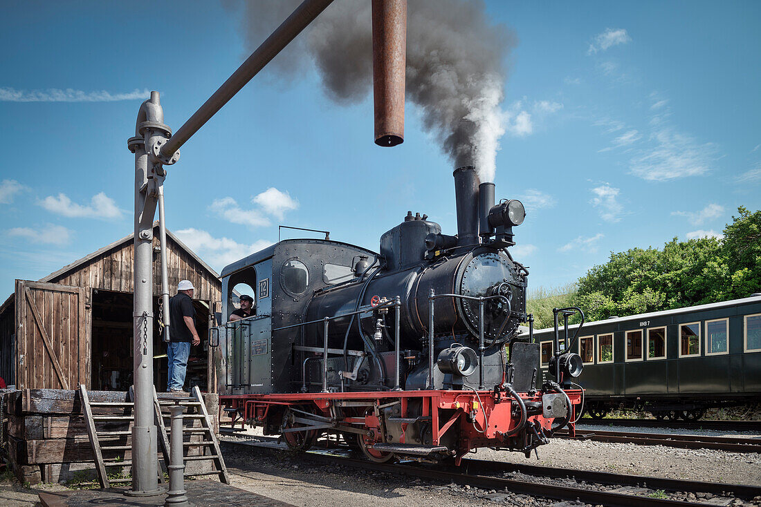 historical steam train close to Benedictine abbey at the so called Haertsfeld, Neresheim, Ostalb district, Swabian Alb, Baden-Wuerttemberg, Germany