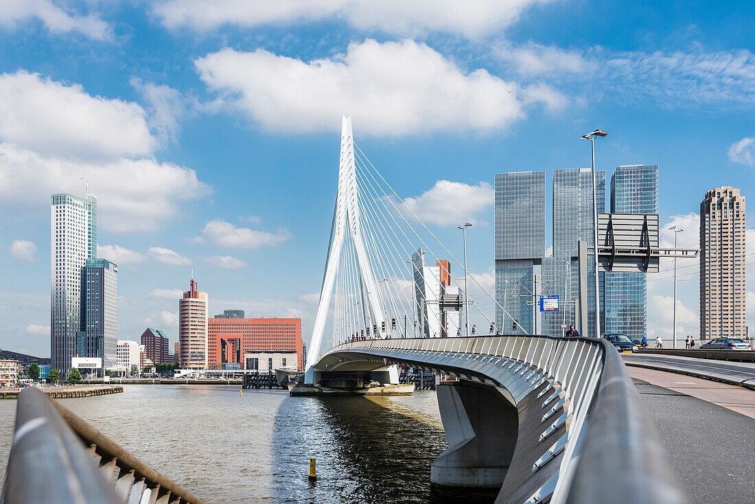 The Erasmus bridge with view to the skyline and high rise buildings on the south shore of the river Maas, Rotterdam, Netherlands