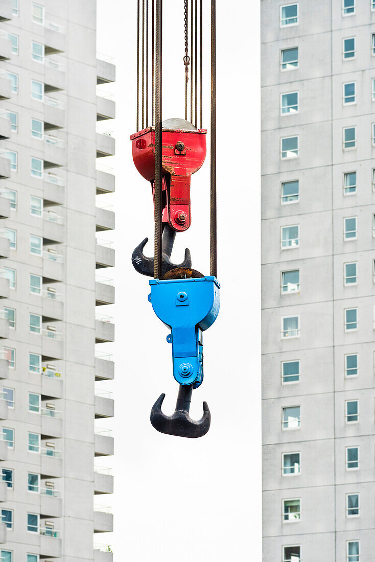 The hooks of an old crane in the Leuvehaven in front of the scenery of residential high rise buildings, Rotterdam, the Netherlands