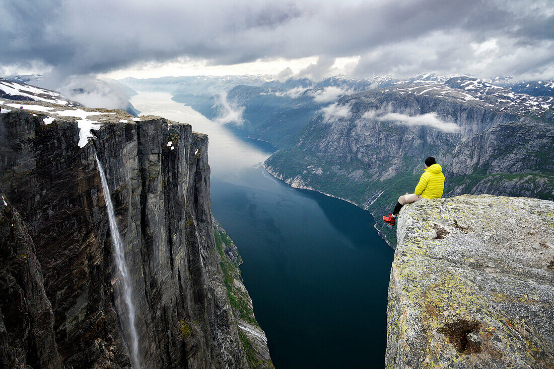 Norway, Rogaland, Lysefjord, Kjerag (Kiragg), hiker watching the fjord 1000m below.