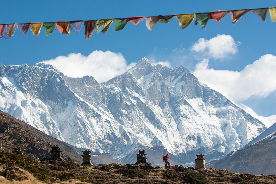 A trekker on their way to Everest Base Camp, Mount Everest is the peak to the left with some spindrift blowing from the top, Himalayas, Nepal, Asia