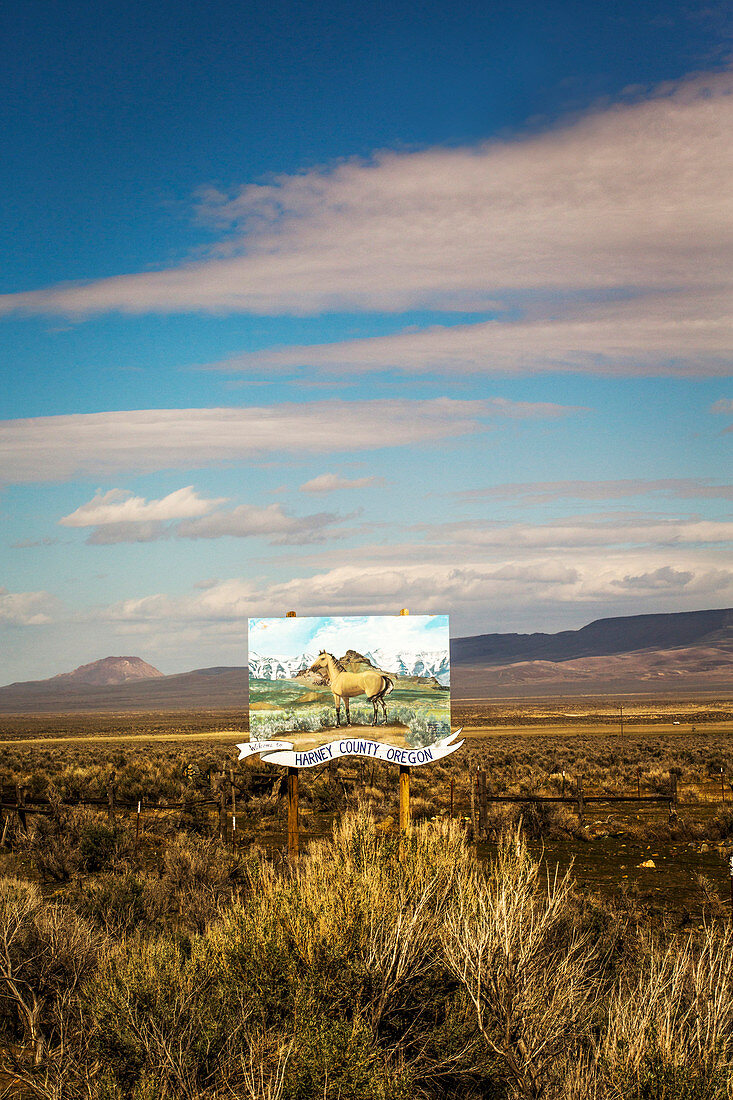 A painted horse on a wooden billboard marks the southern entrance into Harney County in southeast Oregon, one of the most remote and unpopulated areas in the Lower 48