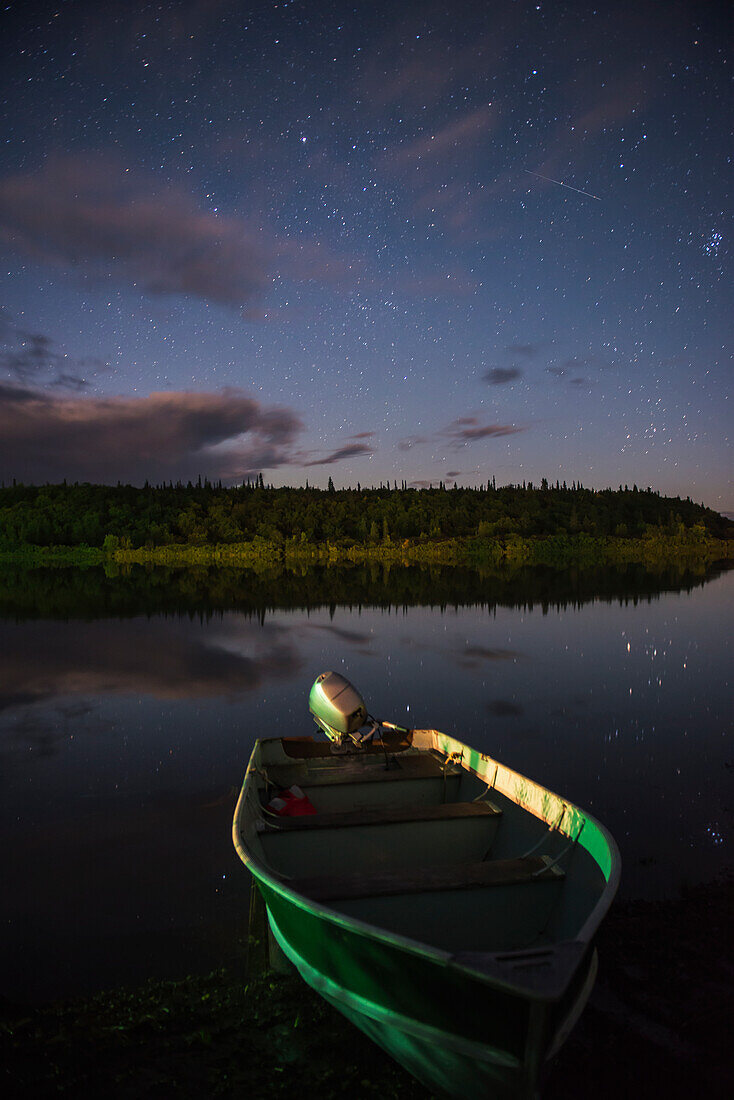 A skiff rests on the banks of the Kvichak River at night, Bristol Bay Region, Southwest Alaska.