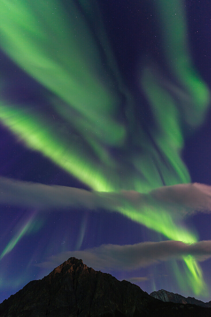 The aurora borealis fills the sky over Mt. Dillon in the Brooks Range north of Wiseman, Arctic Alaska.
