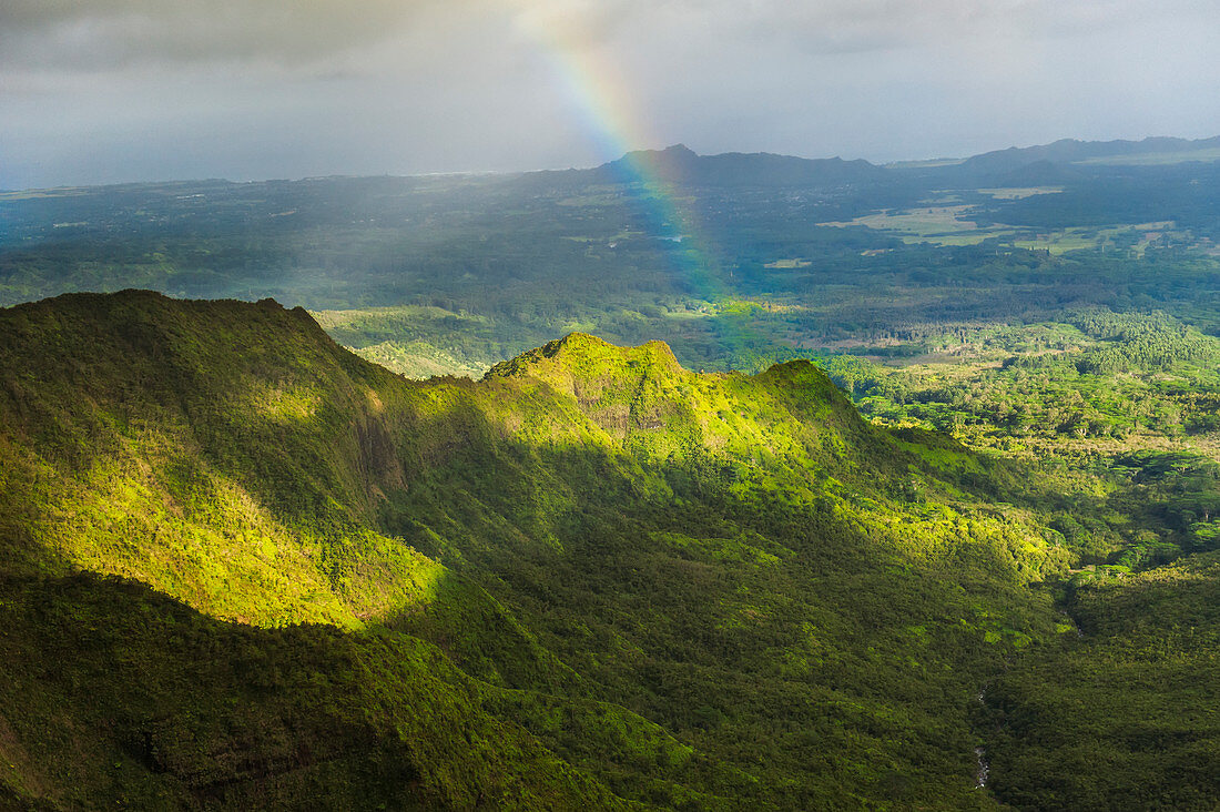 'Rainbow over a ridge near the center of Kauai; Kauai, Hawaii, United States of America'