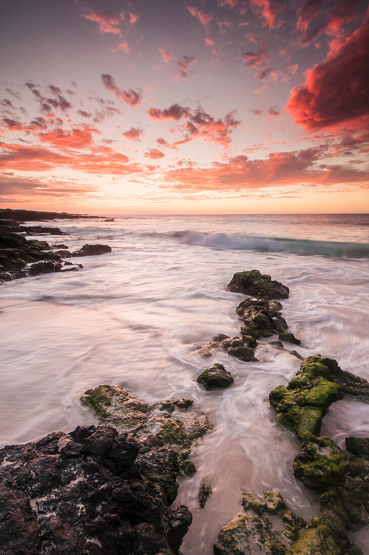 'Vivid pink clouds dominate the sky after sunset in this view from the Kona-Kailoa coast; Island of Hawaii, Hawaii, United States of America'