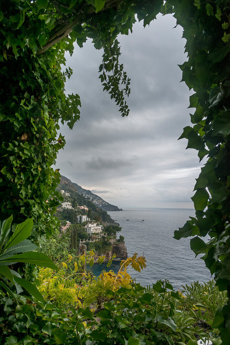 'Lush foliage framing the view of the Amalfi coastline; Positano, Campania, Italy'