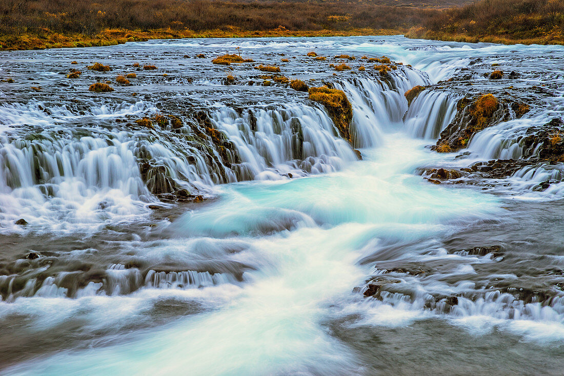 'Water cascading over rocks and flowing into a river; Bruarfoss, Iceland'