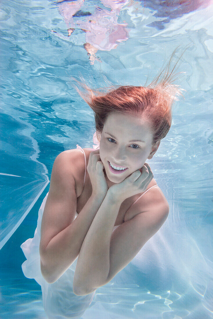 Caucasian woman posing in pool
