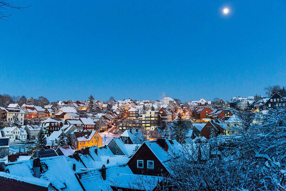 Winter sport centre Sankt Andreasberg, view of the town at dusk, full moon, snow covered roofs, ski area, Harz, Sankt Andreasberg, Lower Saxony, Germany