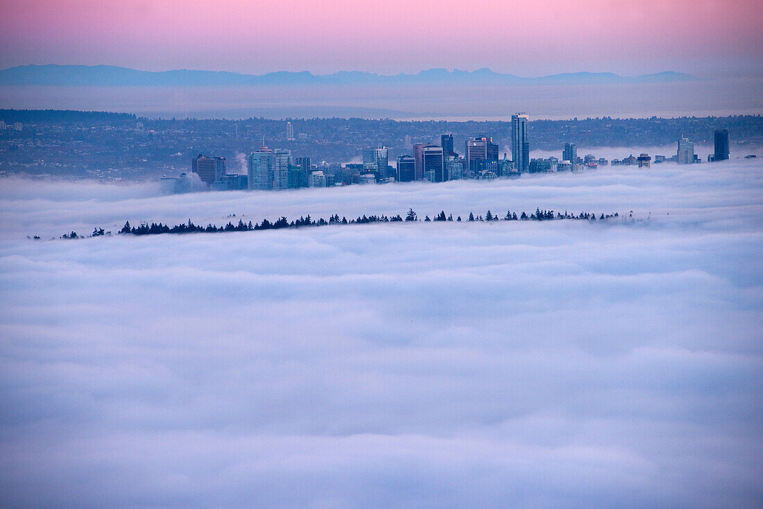 Fog inversion over downtown Vancouver and Stanley Park. Vancouver, British Columbia