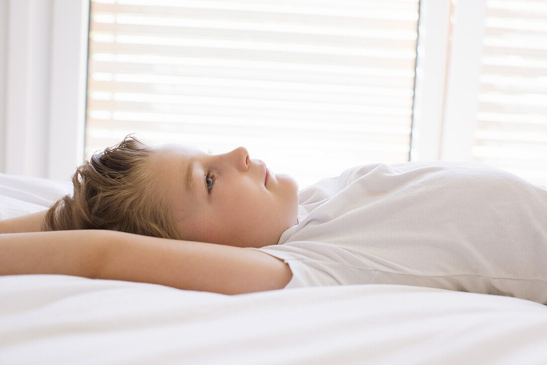 Boy relaxing on bed