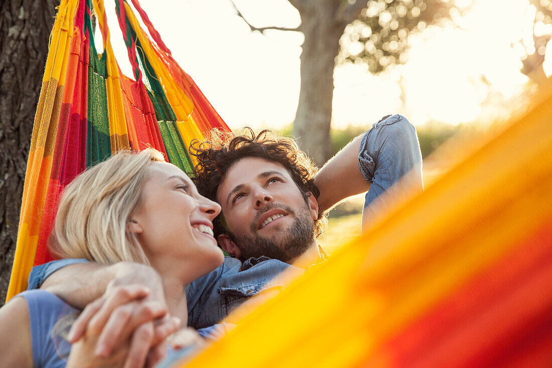 Couple relaxing together in hammock