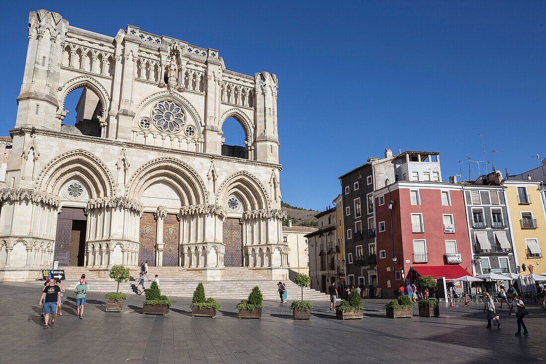 Tourists walk near the facade of the Cuenca´s Cathedral, The cathedral is dedicated to St Julian, gothic english-norman style, XII century, called the Basilica of Our Lady of Grace.
